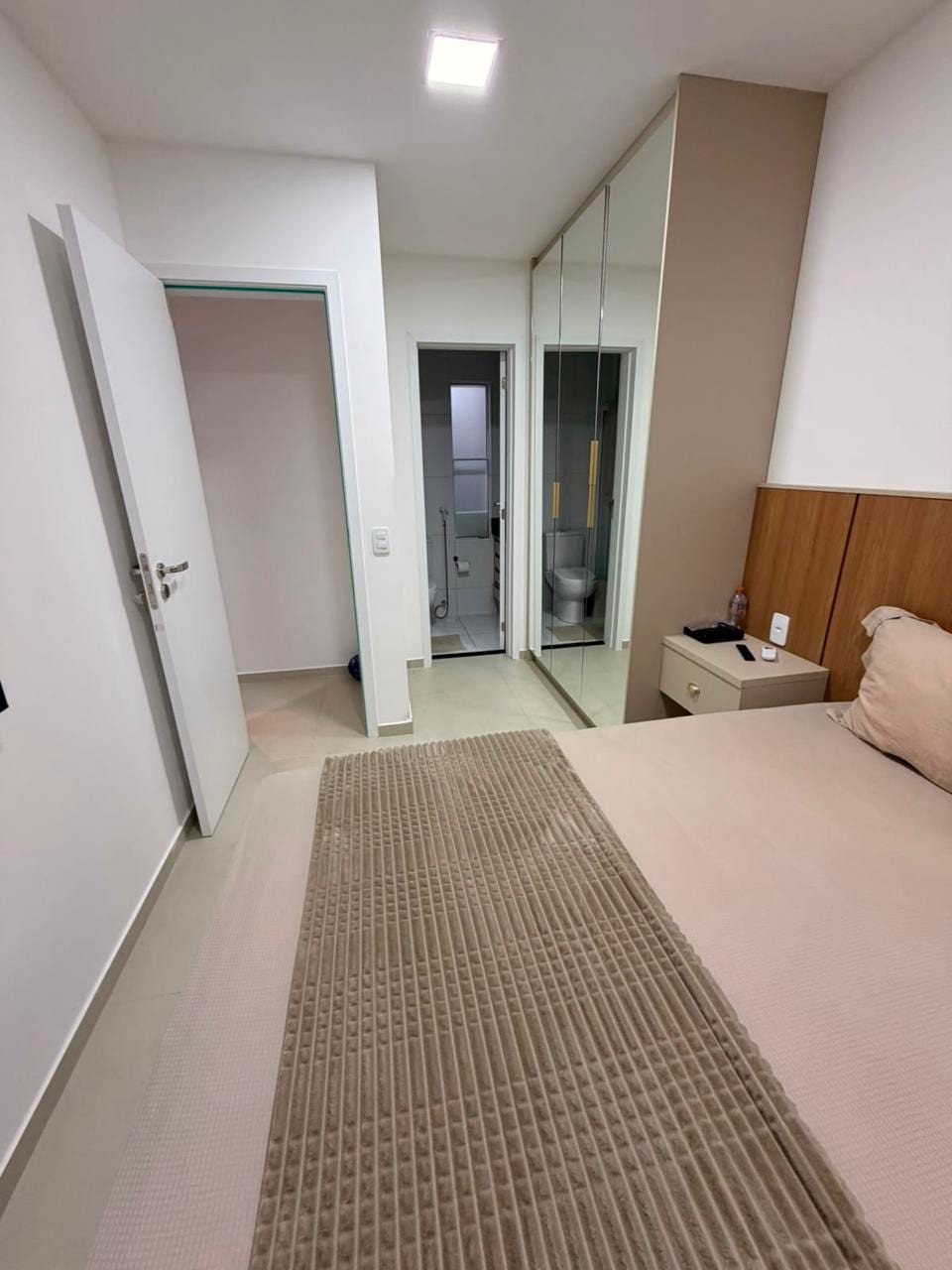 Furnished bedroom with mirrored fitted wardrobe
