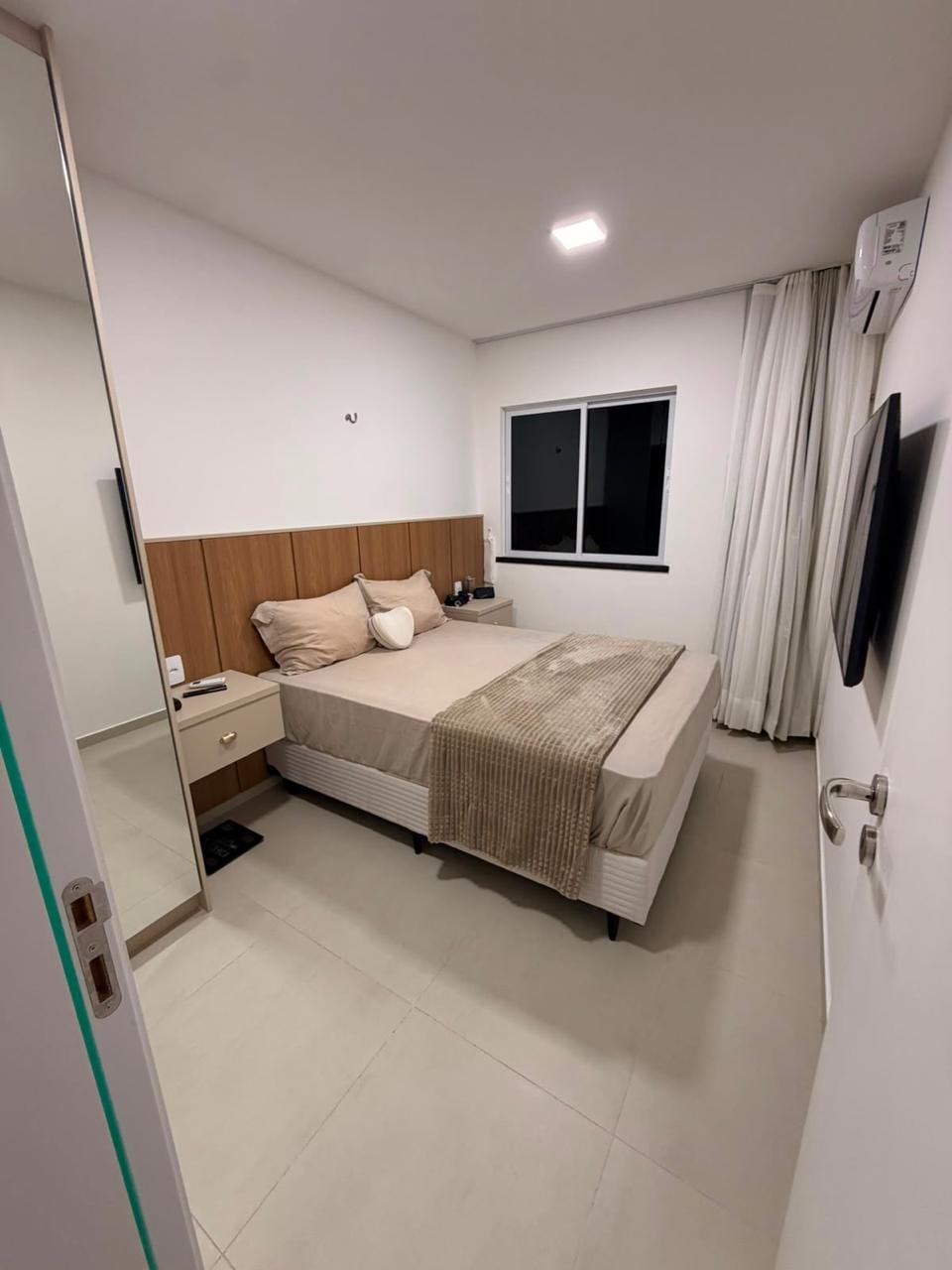 Furnished bedroom with air conditioning and television