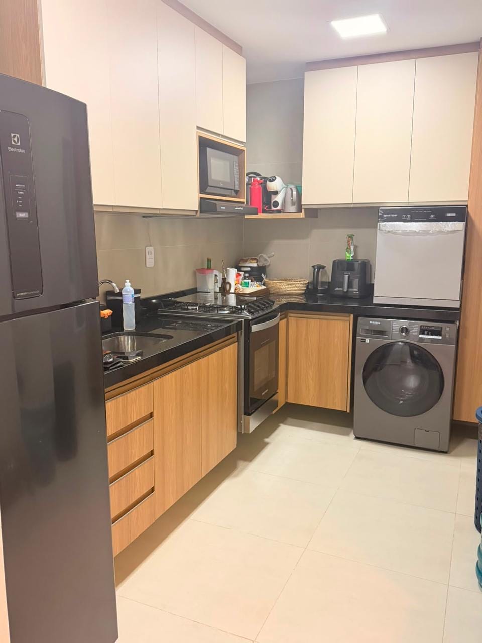 Open kitchen with appliances and laundry area