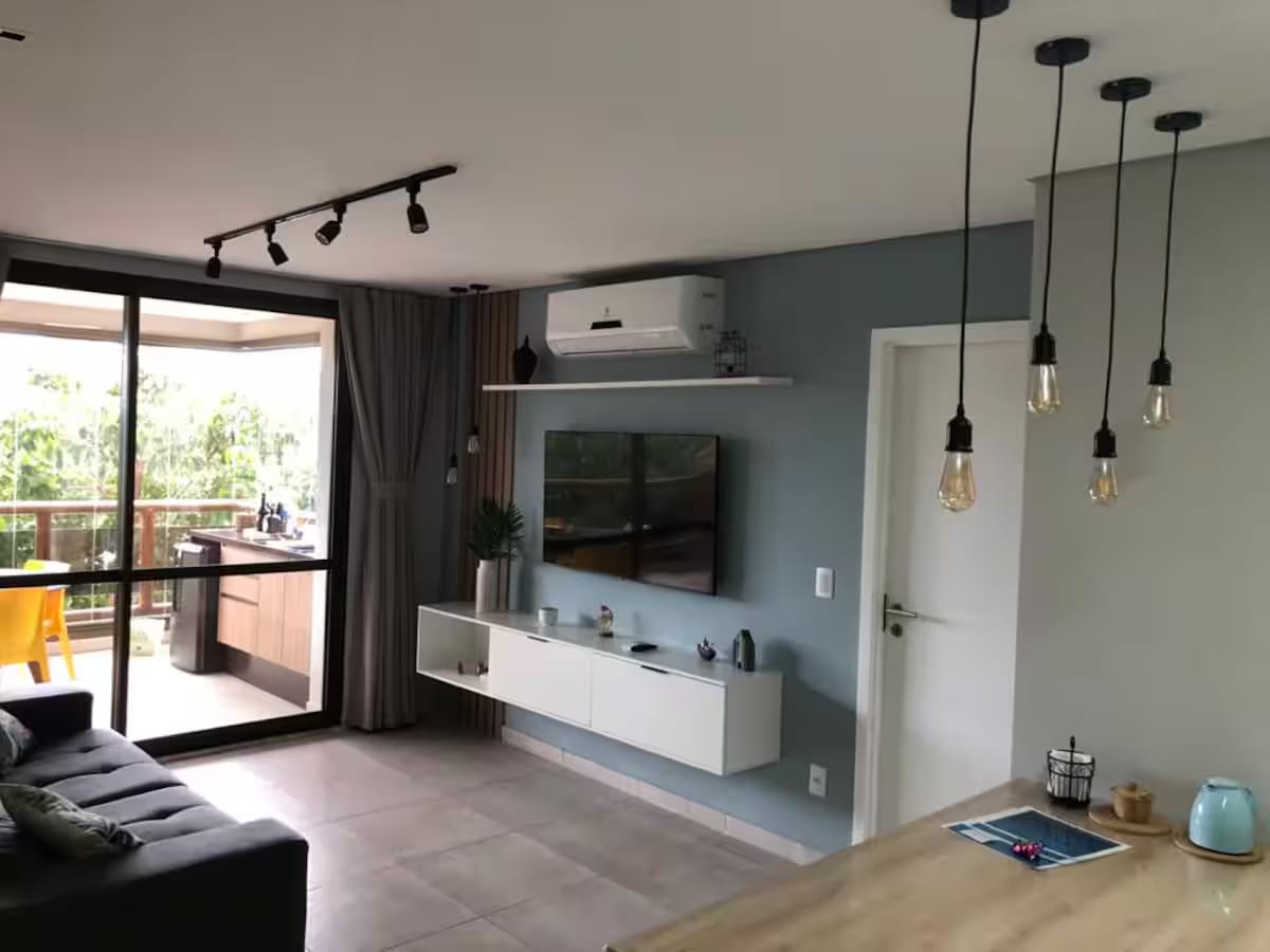 Living room with sofa, TV and access to the balcony
